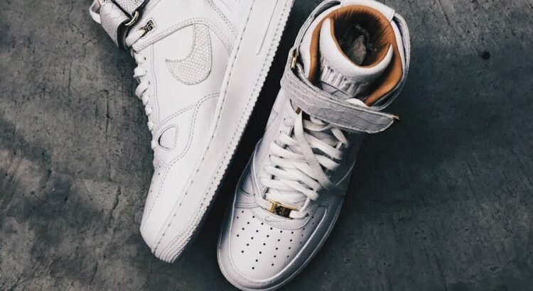 pair of white Nike high-top shoes